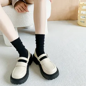 Cute Japanese style black socks paired with cream thick-bottom Mary Jane shoes for women.