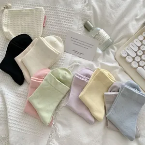 Flatlay detail view of colorful casual mid-tube socks displayed with aesthetic daily props.