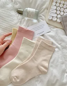 Detail view of cute Japanese style JK mid-tube socks in soft cream and pastel colors.