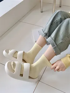 Comfortable mid-calf socks paired with stylish thick-sole casual slides for daily indoor wear.