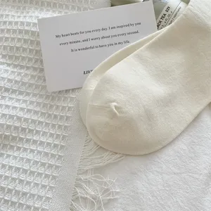 Close-up detail of white vertical striped women socks in soft cotton, clean ins style.