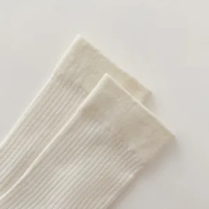 White ribbed knit socks detail close up, breathable cotton blend thin mid calf hosiery for women.