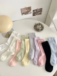 Set of colorful women thin mid-tube socks in white, pink, yellow, black and pastel shades.