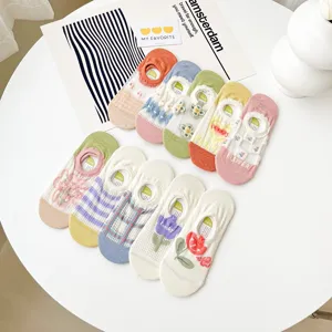 Detailed close-up of colorful mesh summer women boat socks featuring cute floral and smiley designs.