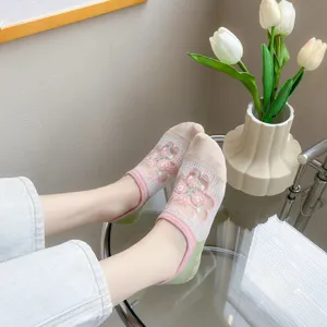 Close-up detail of women breathable mesh glass silk short socks with cute floral embroidery.