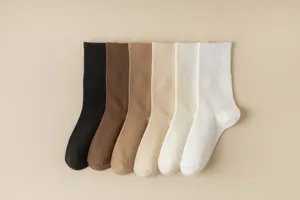 Detail view of women's ribbed mid-tube cotton socks in multi-color gradient display.