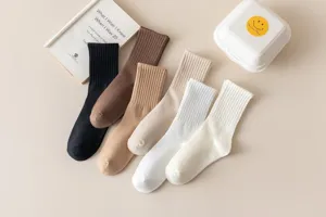 Detailed view of women's ribbed mid-tube cotton socks in assorted neutral colors, soft fabric texture.