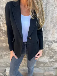 Dettaglio blazer casual da donna in misto lana con collo a risvolto e chiusura a bottone.