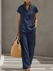 Detail shot of women's casual linen short sleeve top and long pants set in dark blue.