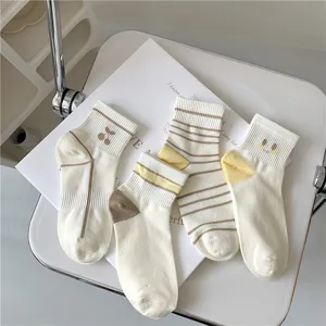 Close-up details of Japanese style cute striped and embroidered short socks for women.