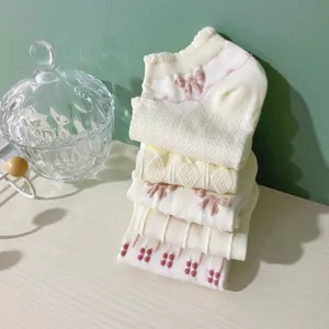 Detailed view of sweet Japanese style women socks stacked neatly with lovely bow and flower patterns.