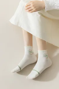 Detail view of cute Japanese style women short socks with green stripe and smile embroidery design.