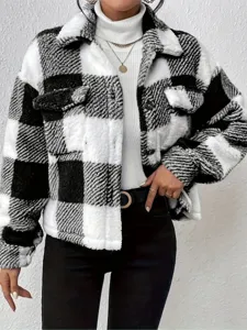 Detail view of women's black and white plaid fuzzy shacket, cozy sherpa jacket with button front.