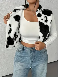 Women cow print fuzzy zip up vest paired with white long sleeve top and blue jeans for autumn.