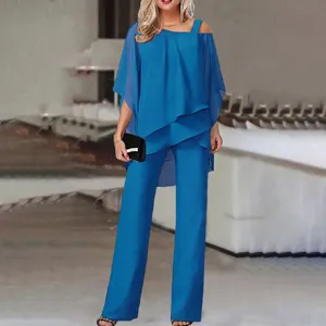 Detailed close-up shot of the elegant blue asymmetric batwing sleeve two-piece outfit.