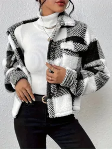 Detailed view of the black and white plaid sherpa shacket, featuring cozy fleece and chic buttons.