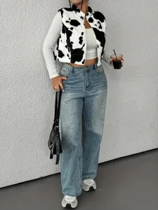 Cow print plush zip vest detail shot, stylish fuzzy outerwear layered with casual denim jeans.