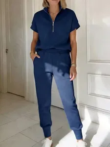 Vista dettagliata del completo sportivo blu scuro con zip e pantaloni coordinati.