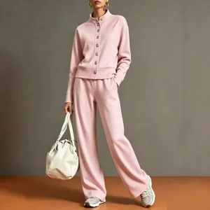 Detailed view of women pink tracksuit featuring stand collar cardigan and wide leg pants.