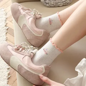Detail shot of cute Japanese style mesh socks with cartoon cat pattern and sweet ruffled edge.
