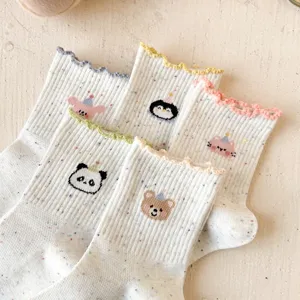Close-up of cute cartoon embroidered socks with colorful speckled yarn and lettuce edge design.