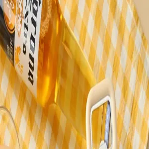 Kitchen peeler and bottle opener tool with white handle for daily home cooking use easily.