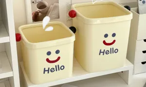 Mini desktop trash can with cute smiley face design, perfect for dorm, office, and living room.