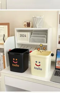 Mini desktop trash can with cute smiley face design, perfect for office, dorm and living room.