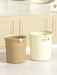 Detailed view of the plastic garbage bin featuring cute bear pattern and vertical stripes.