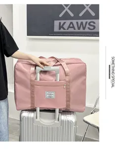 Pink travel duffel bag detail, large capacity waterproof storage bag with luggage sleeve.