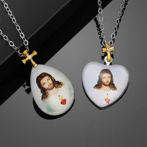 Jesus pendant necklace set featuring heart and teardrop shapes with rhinestone cross design.