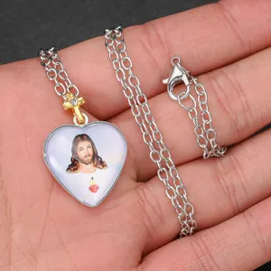 Gold diamond cross crystal pendant necklace, heart shaped Jesus portrait religious jewelry item.