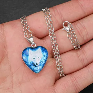 Close-up detail of the men's blue glowing wolf totem heart pendant necklace on display.