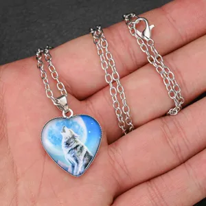 Close-up detail of the silver-tone heart pendant necklace featuring a howling wolf design.
