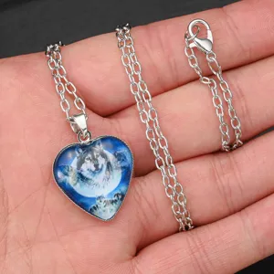 Close-up view of wolf totem heart glass pendant necklace detailing silver chain texture