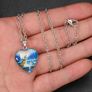 Men's silver tone wolf totem glass heart pendant necklace, detailed view of jewelry.