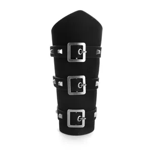 Detail shot of men punk medieval leather bracer, black wide arm guard with metal buckles.