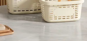 Plastic hollow shower basket detail, portable storage box with handle, beige bathroom organizer.