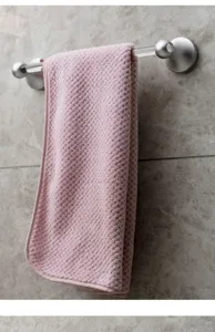 Modern luxury acrylic towel bar detail shot showing transparent rod and silver mounts.