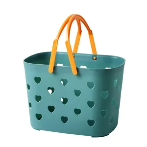 Cute green shower basket with orange handles and heart hollow design for bathroom storage.