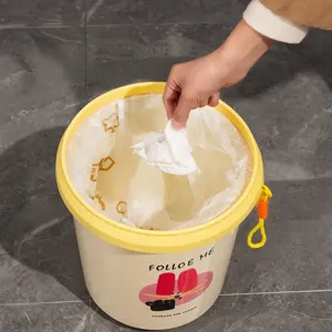 Cute household trash can with wide opening yellow lid and cartoon design for room use.