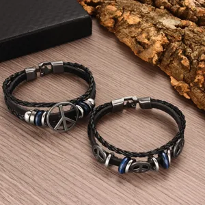 Details of vintage multi-layer braided leather bracelet with peace symbol charms and alloy clasp.