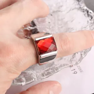 Closeup detail shot of the men retro chunky alloy ring featuring a square red faceted gemstone.