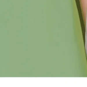 Close-up detail shot of the soft green cotton slipper upper and dark green fabric binding.