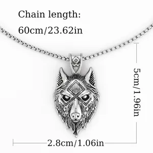 Close-up detail shot of vintage wolf head pendant necklace, showcasing intricate metal carving.