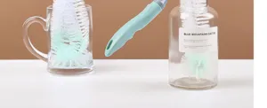 Long handle cleaning brush detail view for cups bottles and glassware deep cleaning with green handle.