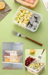 Portable plastic bento box with multiple compartments for fresh fruit and student meals.