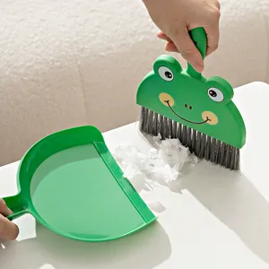 Mini desktop broom and dustpan set, cute green frog shape cleaning tool for kids school desk.
