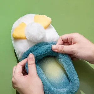 Plush cotton slippers for women and men, winter warm cozy indoor shoes with cute duck design.