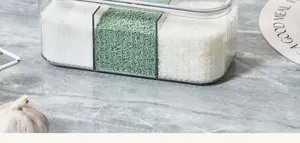 Multi-compartment clear plastic seasoning box for kitchen countertop storage and organization.